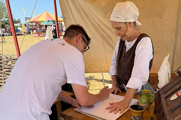 Richard signing with quill