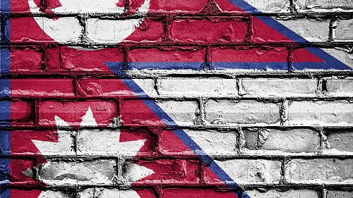 Nepal flag on brick wall background