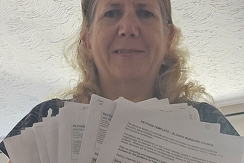 Jen Simpson with some of the 1,700 signatures on the petition she led
