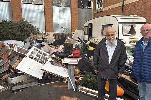 Cllr Usman Bhaimia and a local resident outside the former school