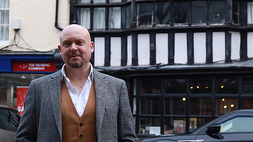 Cameron outside Tudor building